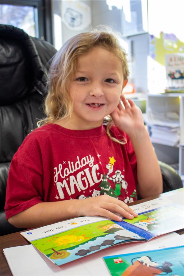 girl smiling with open book